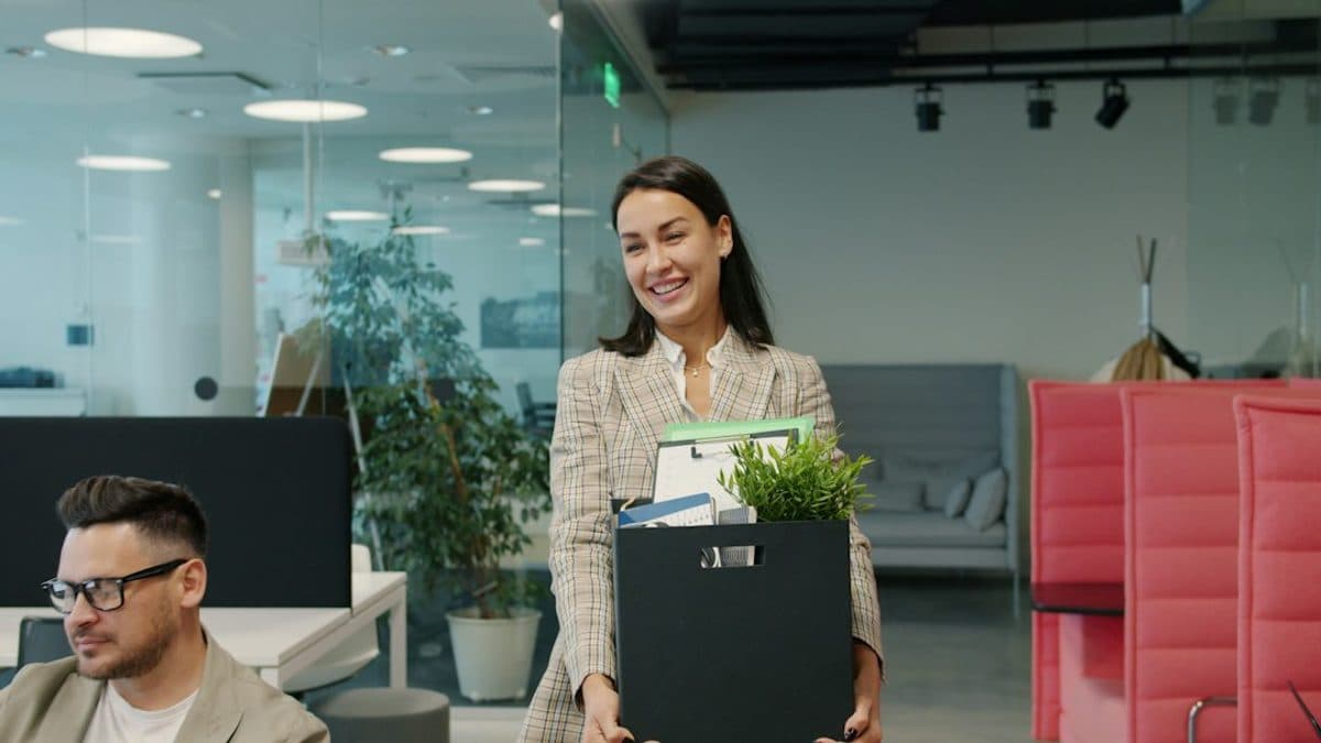 Employee leaving the office with a box of belongings, the moment a vibe-coded app on a personal account loses its owner